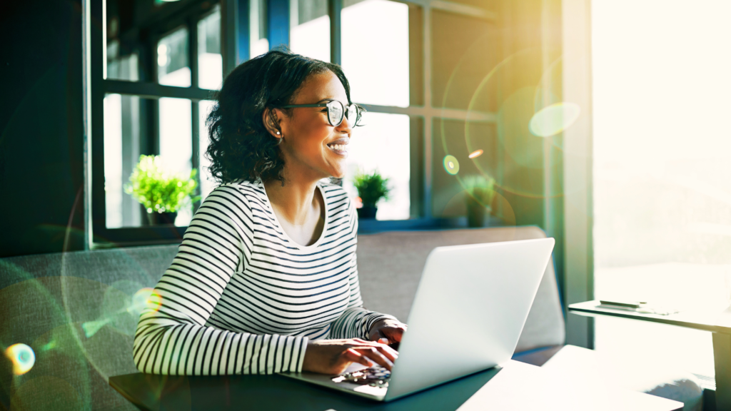 Beautiful Black Woman sitting at her desk working on her estate plan.