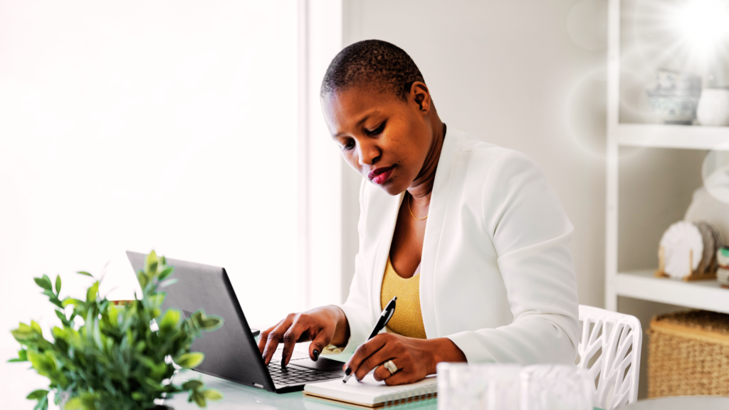 Beautiful Black Woman working in her home office.