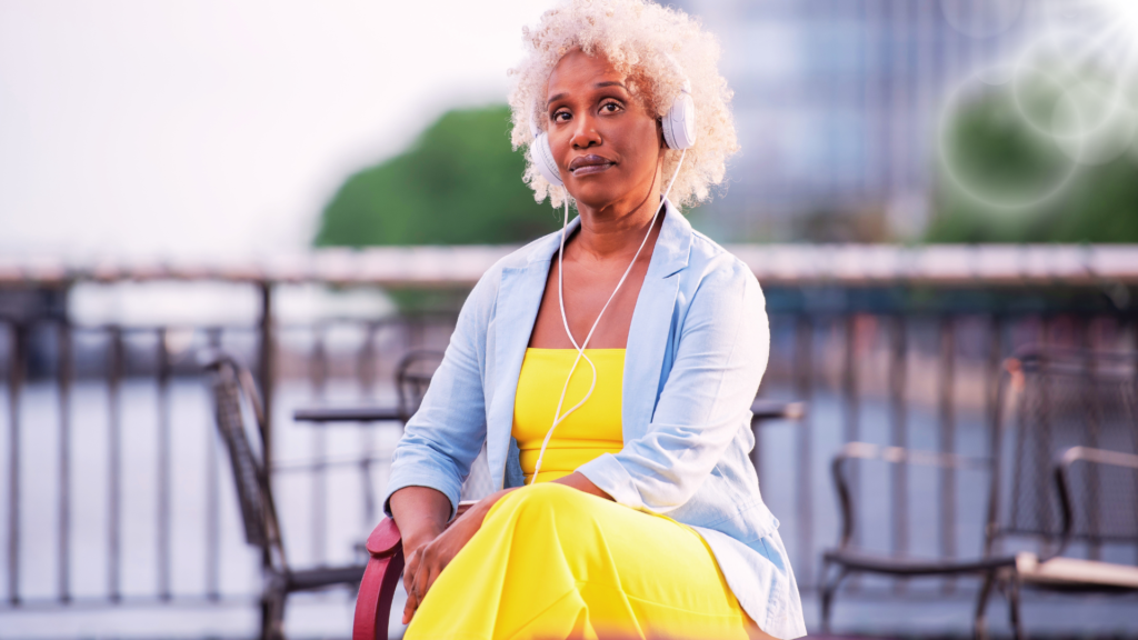 Gorgeous middle aged African American seated on a park bench.